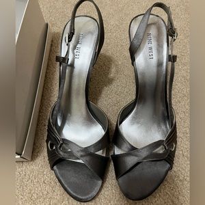 Women’s size 11 heels (4”). Brand new, never been worn. Dark grey/silver.